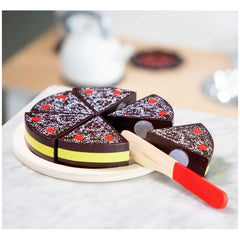 New Classic Toys Cutting Cake features a glossy dark brown cake with lighter stripe, sliced into four pieces on a white plate