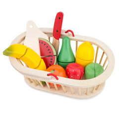 Wooden basket filled with colorful plastic fruit slices including watermelon, banana, apple, orange, and lemons.