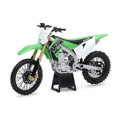 New Ray Japan dirt bike model features a green plastic frame, white seat, black tires, and metal suspension components.