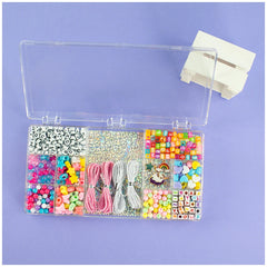 Beads ABC Magic Unicorn 500 set in clear plastic containers with assorted crafting items and spools of thread.