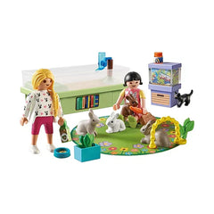 Playmobil Rabbit Family Playset features colorful plastic dolls, a toy house, and various accessories in a vibrant layout.