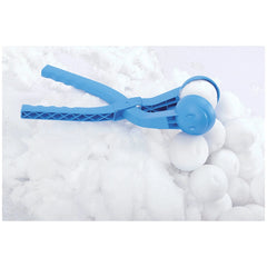 Blue plastic Snowballee 1 snowball maker with white snowballs on a snowy surface, designed for outdoor play.