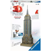 Ravensburger 3D puzzle of the Empire State Building with a glossy box, red and black pieces, and a metallic gold finish.