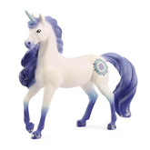 Bayala Mandala unicorn stallion figure with a glossy white body, blue mane, purple horn, and black eyes.