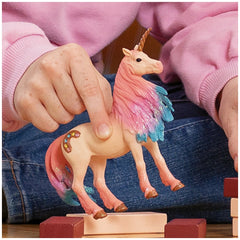 Schleich Marshmallow Unicorn toy figure features a glossy pink and blue horse with a colorful mane and tail.