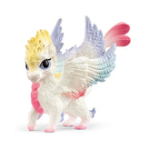 Rainbow Baby Dragon toy figure with white body, glossy wings, pink tail, and colorful eyes, made of matte plastic.