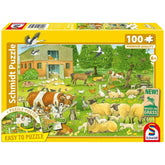 Schmidt Spiele Animal Families on the Farm puzzle box features a colorful farm scene with cartoon animals, a barn, and trees.