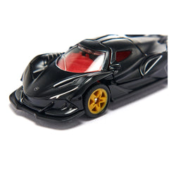 Black toy car with a red interior and yellowish-gold wheels, positioned on a light-colored surface.