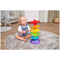 Simba ABC Rainbow Ball Tower with colorful stacking rings and a young child playing on a gray rug in a nursery.