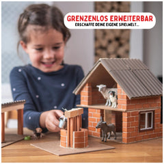 Teifoc well set with a young girl at a wooden table, featuring cardboard materials and plastic figurines in a playful scene.