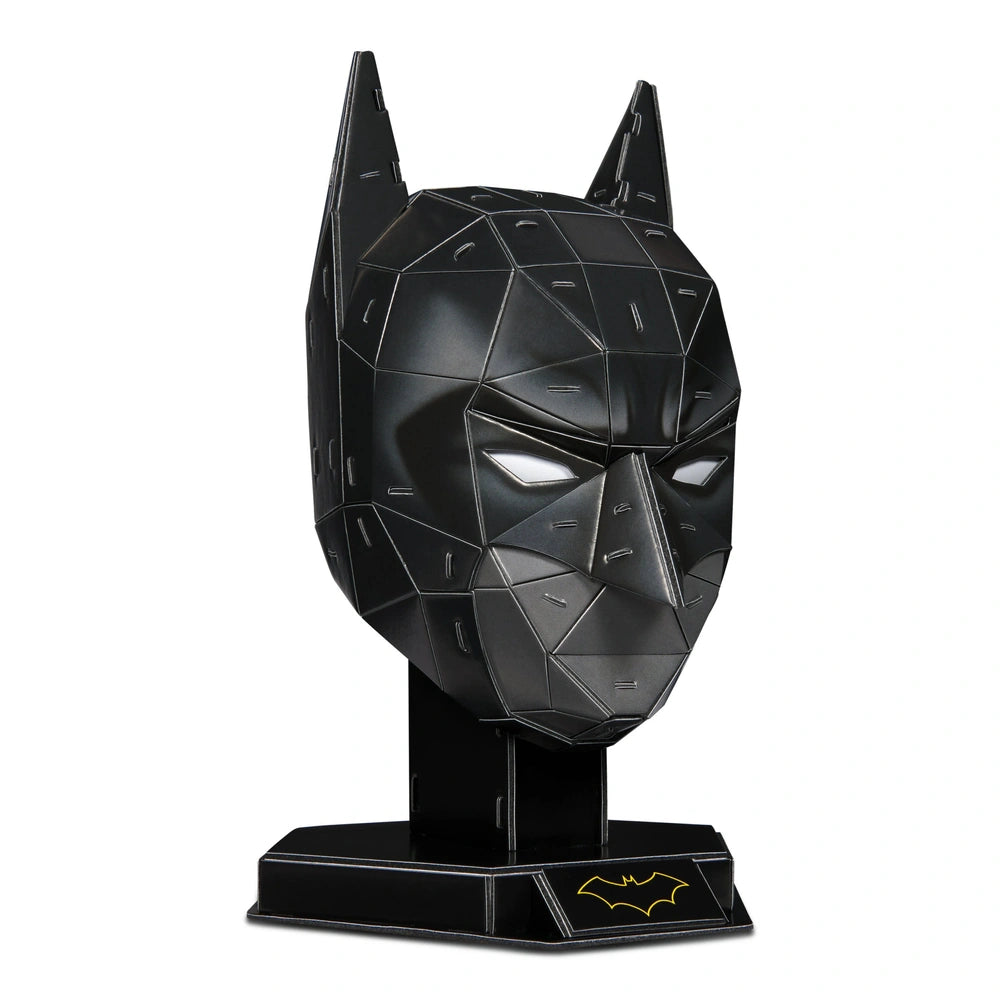 4D Build DC Batman mask puzzle model kit in black with a textured surface and yellow bat symbol, angled towards the viewer.