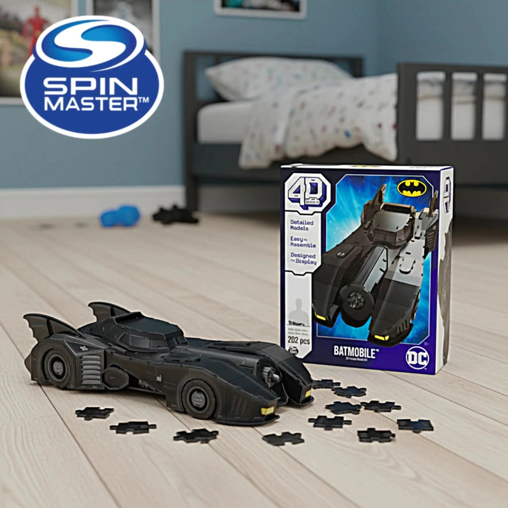 4D Build DC Batman Retro Batmobile 3D Puzzle Model Kit displayed in a room with a blue and white box next to a black toy car.