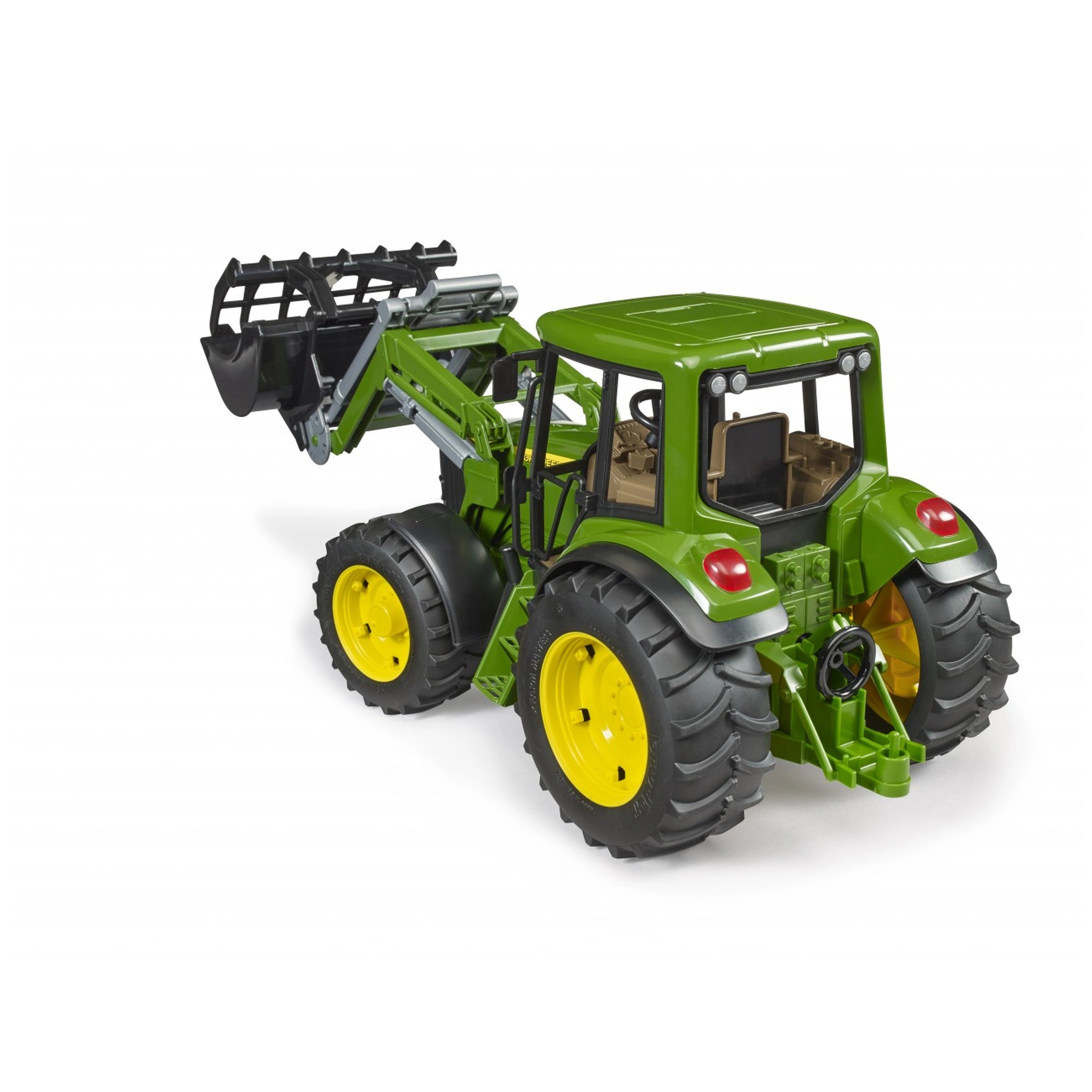 Green and yellow Bruder John Deere 6920 toy tractor with a frontloader, showcasing realistic details and large tires.