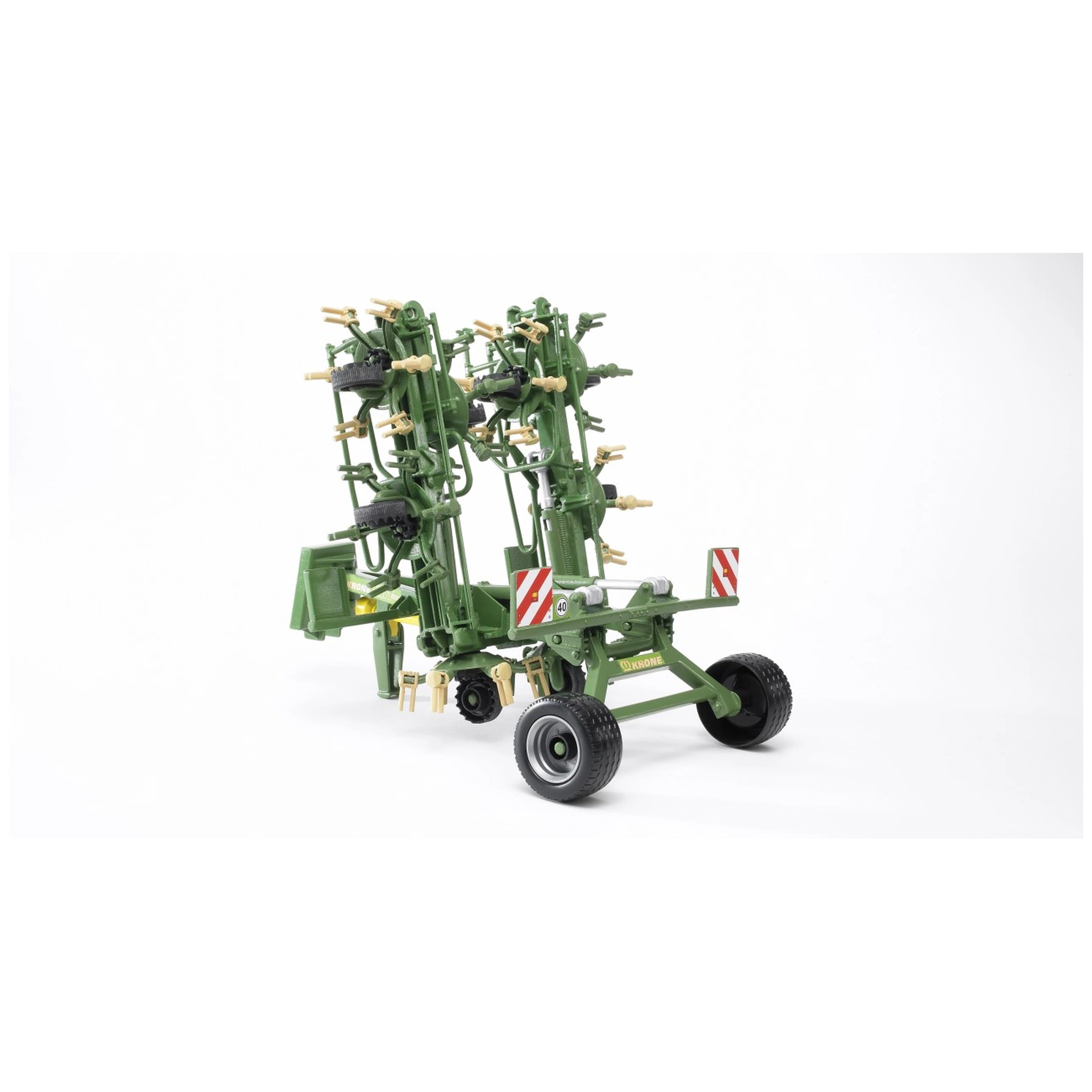 Bruder Krone Trailed Rotary Tedder, green with foldable frame and wheel setup, detailed for farming play.