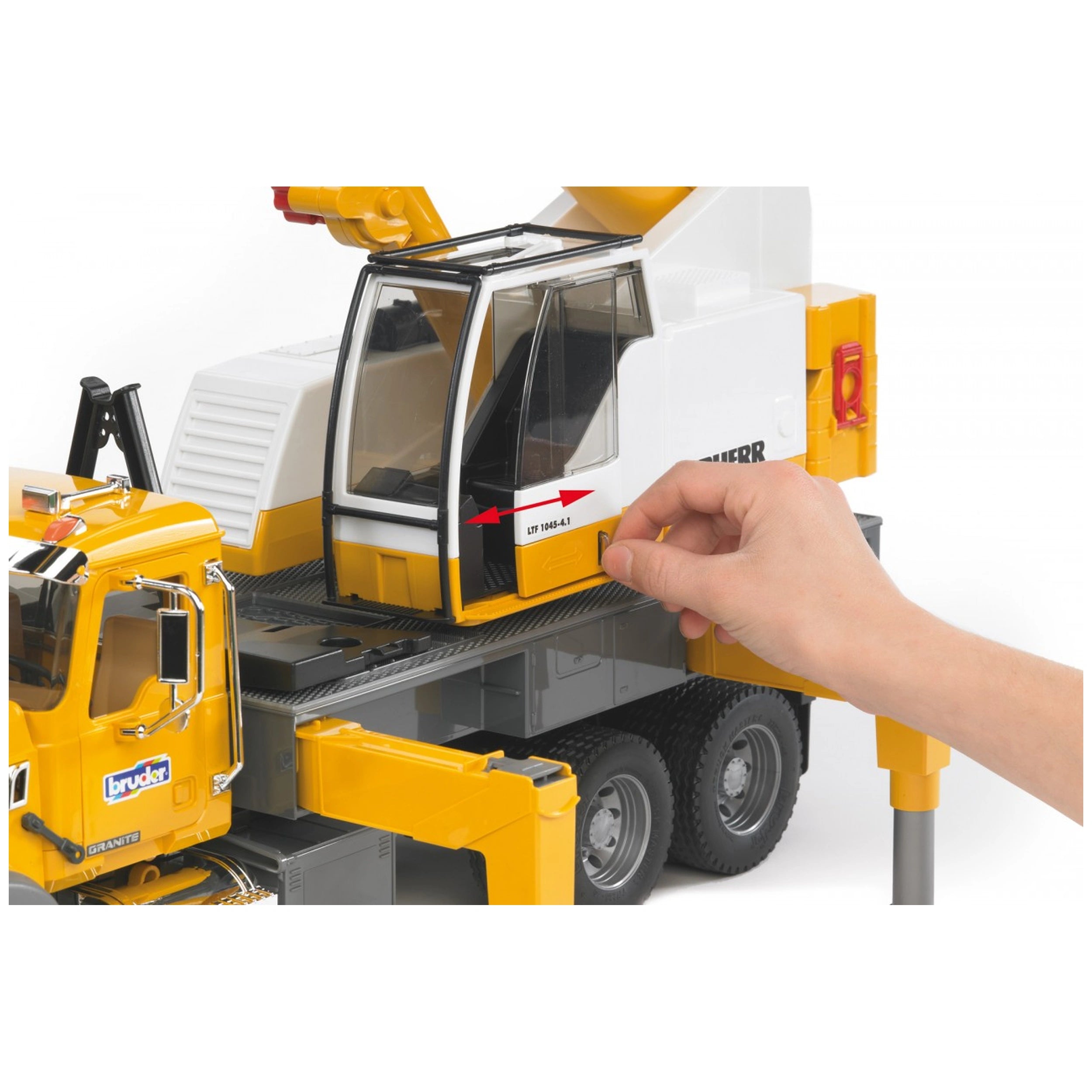 Hand operating Bruder Mack Granite Liebherr Crane Truck with extendable cab and yellow detailing.
