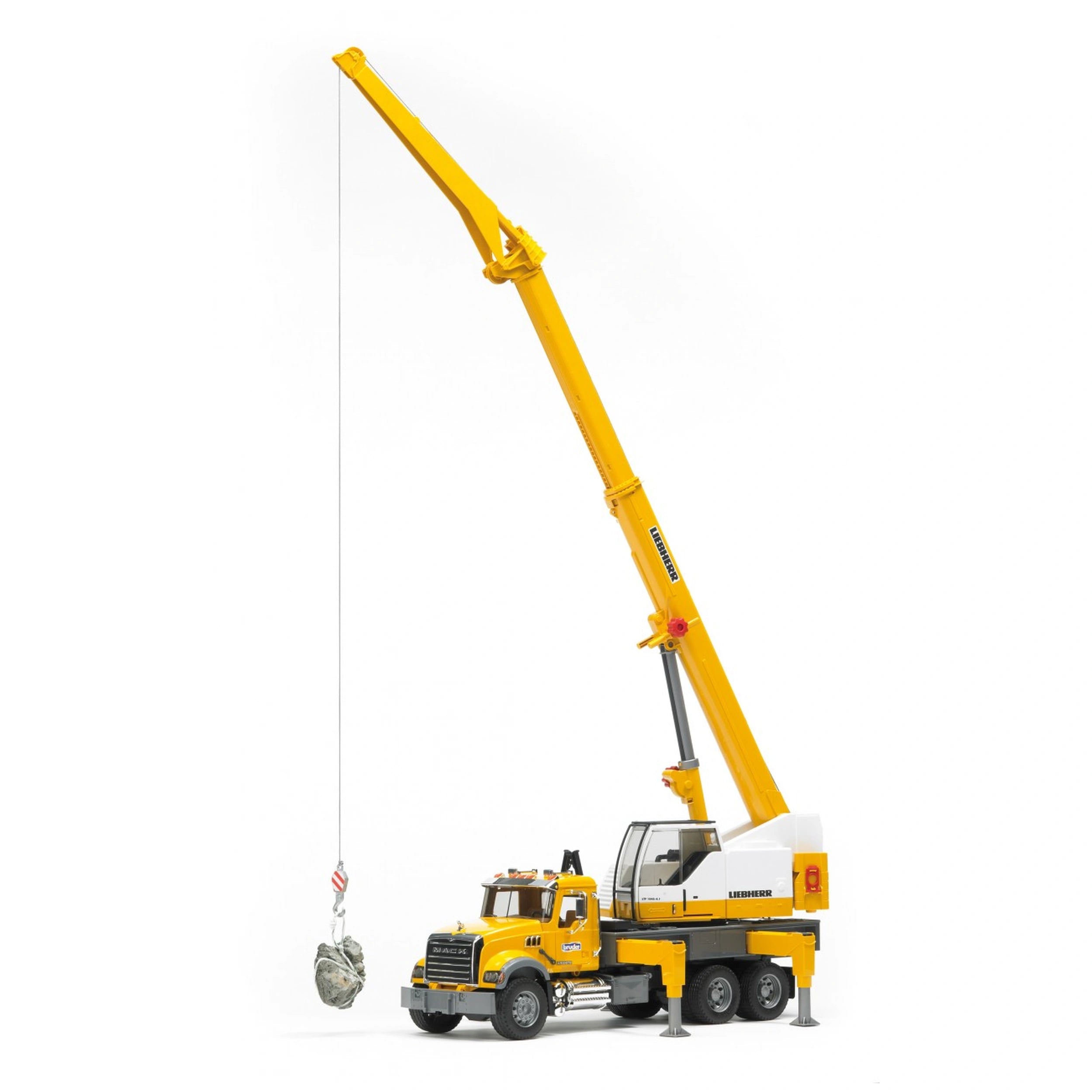 Yellow Bruder Mack Granite Liebherr crane truck with extended telescopic boom and rock suspended, designed for imaginative play.