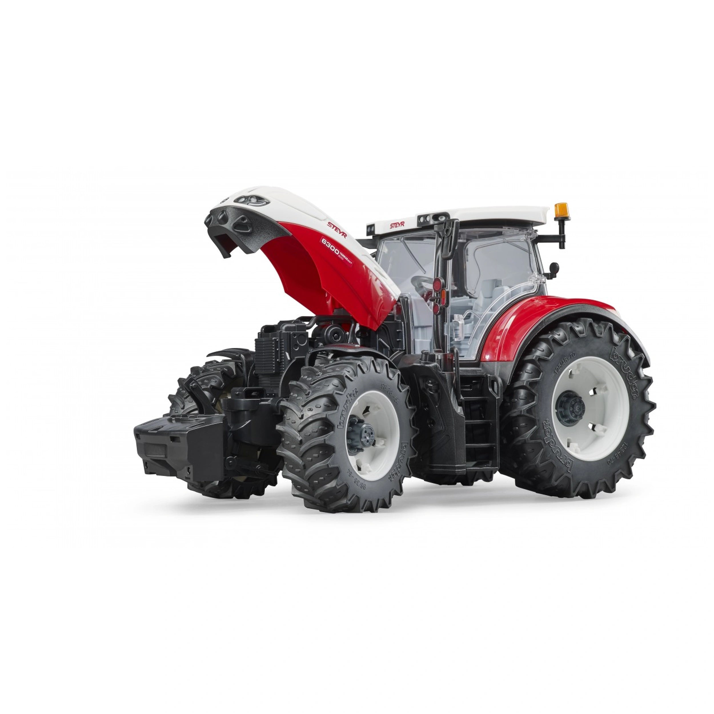 Red and white Bruder Steyr 6300 Terrus CVT toy tractor with open hood, large tires, and detailed cabin.