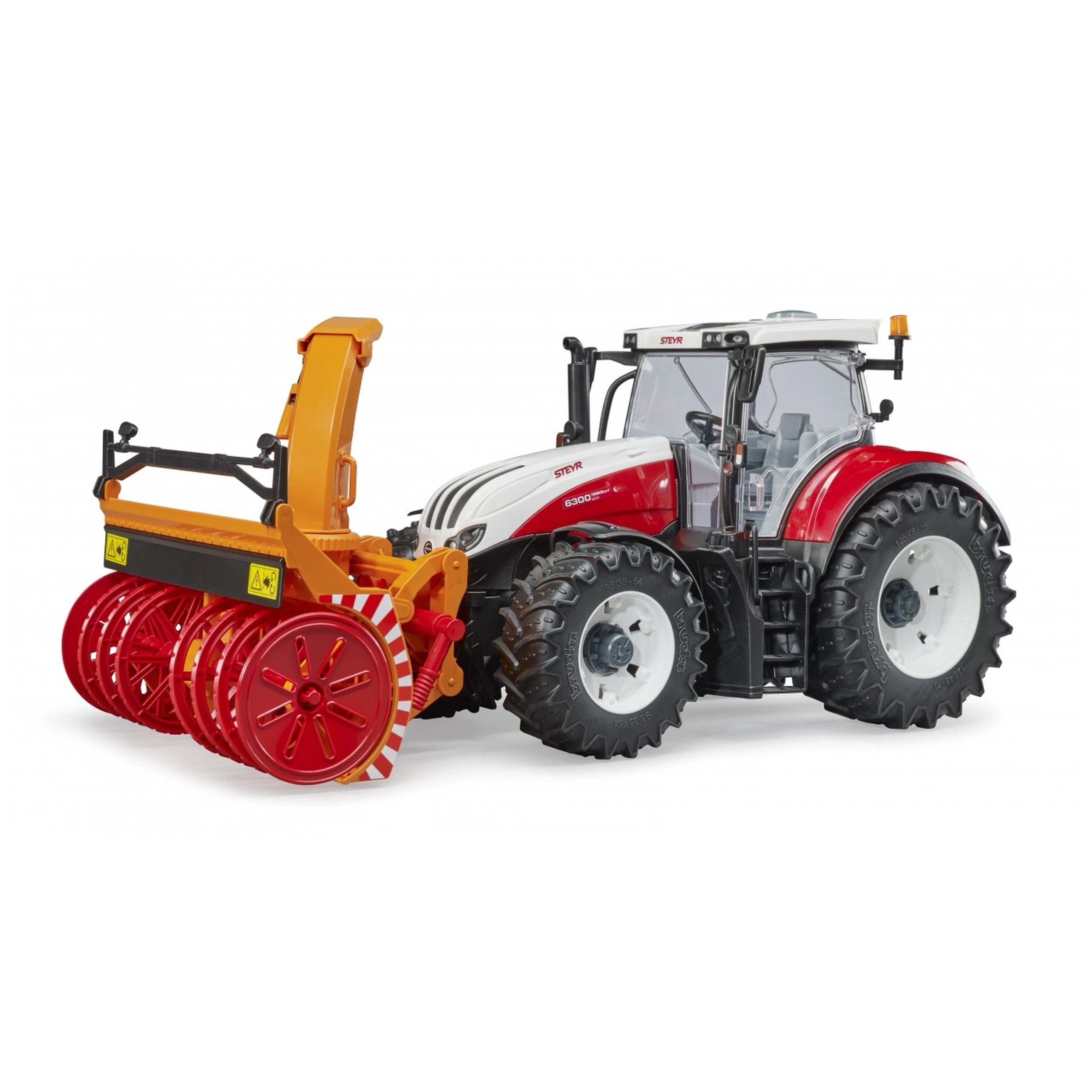 Red and white Bruder Steyr 6300 Terrus CVT toy tractor with detailed cabin and orange-red agricultural attachments.