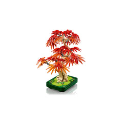 Colorful LEGO® Botanicals Japanese Red Maple Bonsai Tree with vibrant red and orange leaves, set in a dark green pot with decorative grass elements.
