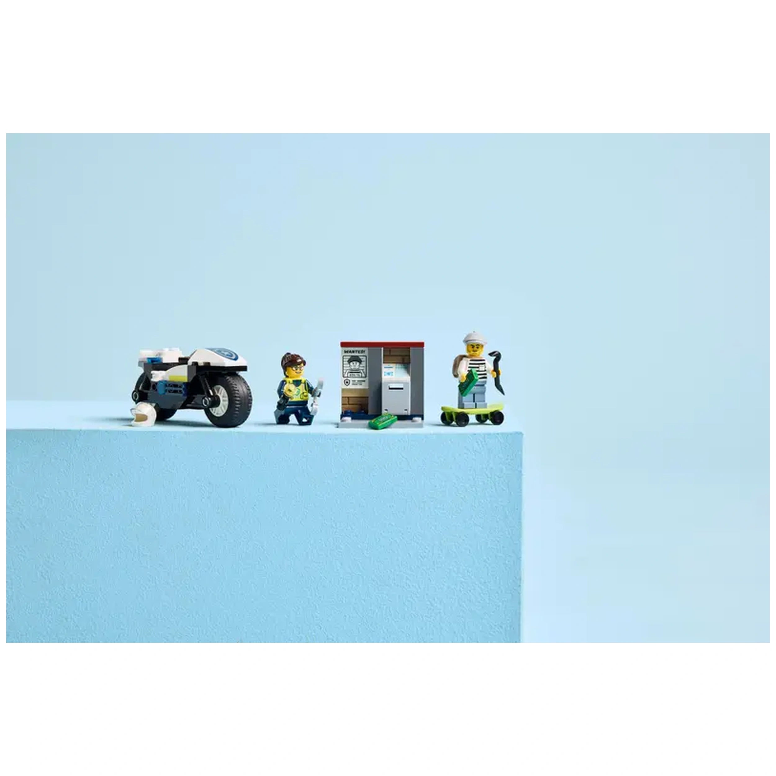 LEGO City Police Motorcycle Chase set featuring a police motorbike, two minifigures, a skateboard, and a backdrop of blue.