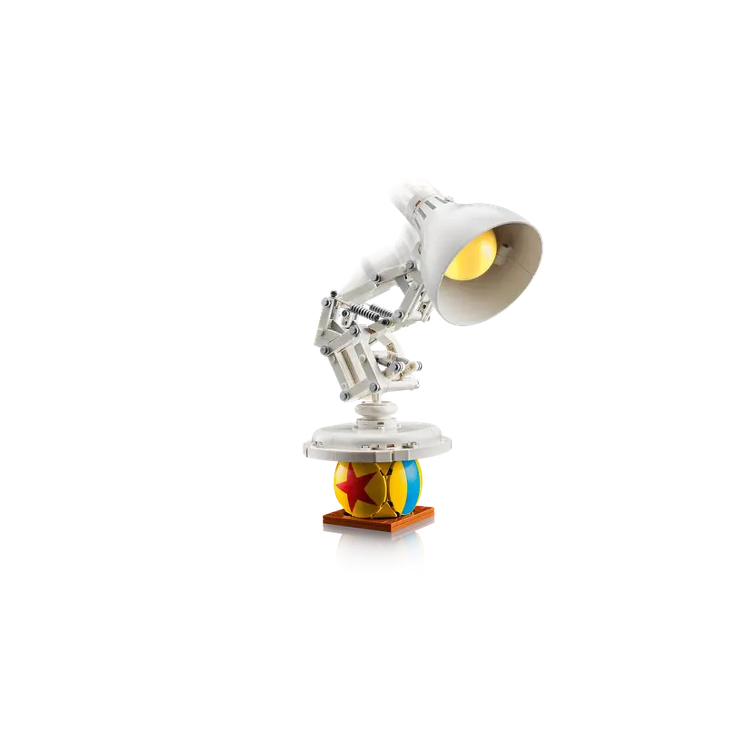 LEGO Disney-Pixar Luxo Jr. model set features a white articulated lamp on a colorful ball base, showcasing playful design and intricate details.