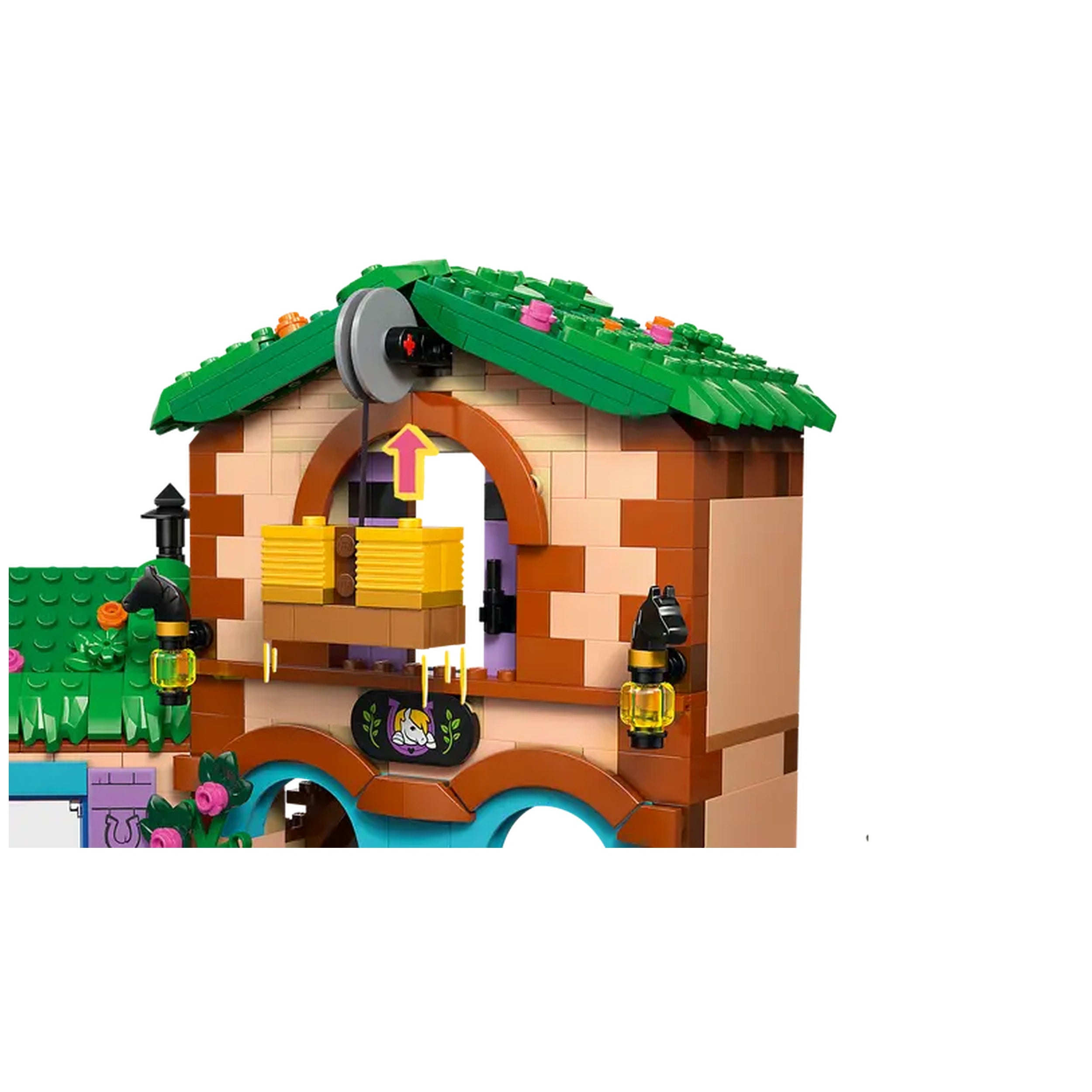 Colorful LEGO® Friends Pony Ranch & Stable set features a brown building with a green roof, lanterns, and a window displaying hay storage.
