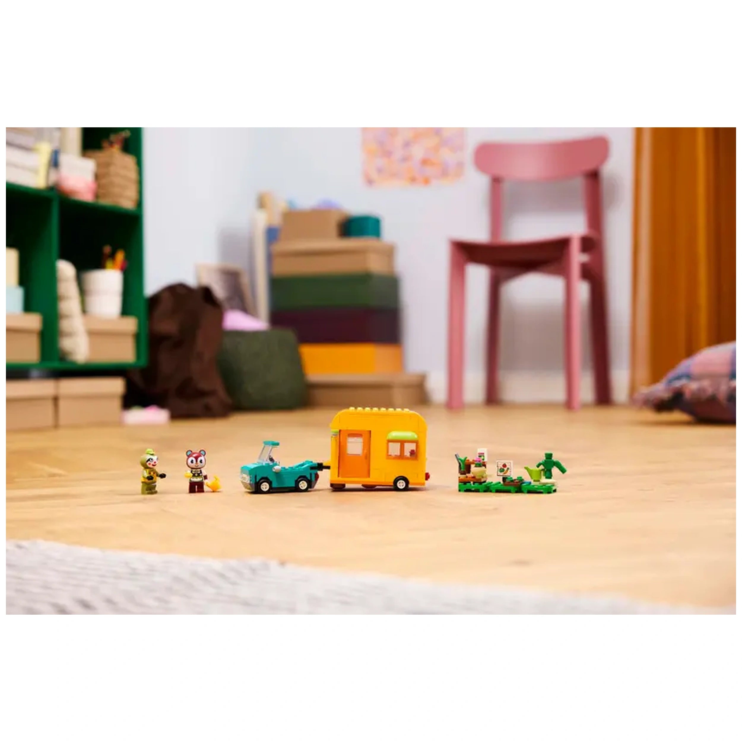 LEGO® Animal Crossing™ Leif's Caravan & Garden Shop playset featuring a vibrant yellow caravan, a blue car, and two minifigures on a wooden floor.