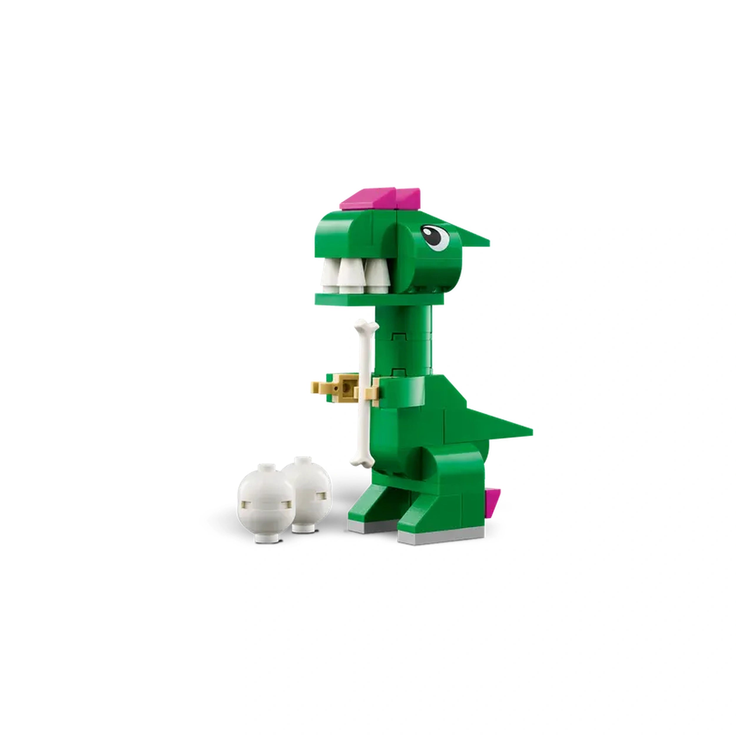 A vibrant green LEGO dinosaur with a pink crest stands proudly, holding a white bone in its mouth. Two small white dinosaur eggs rest nearby, showcasing a playful design perfect for imaginative play.