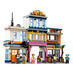 Colorful LEGO® Creator set featuring a vibrant three-floor building with a café, music store, and record store. Mini-figures interact outside.