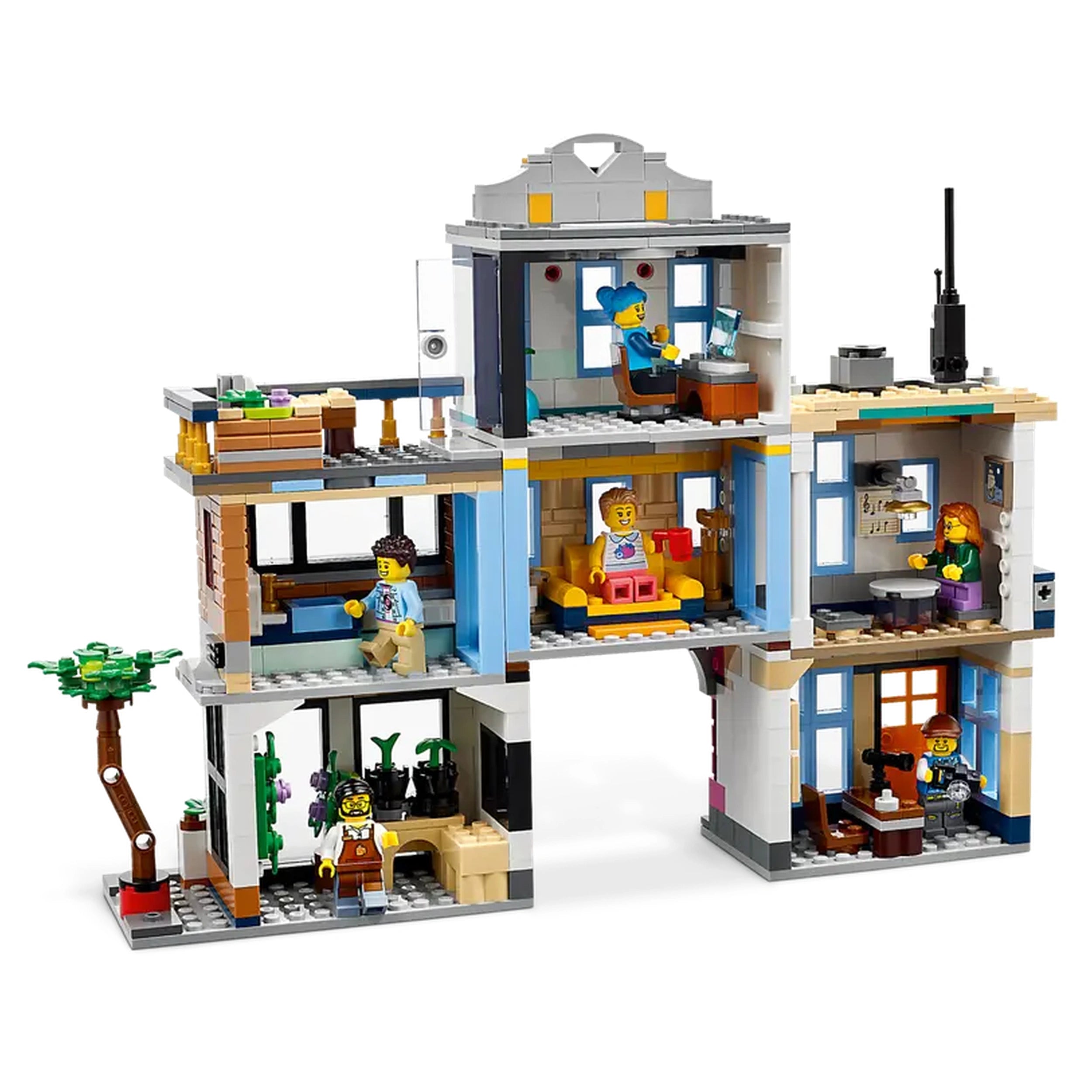 LEGO Creator 3in1 Main Street construction set, featuring four colorful buildings, including a hotel, music store, café, and apartments, with mini-figures engaged in various activities inside.