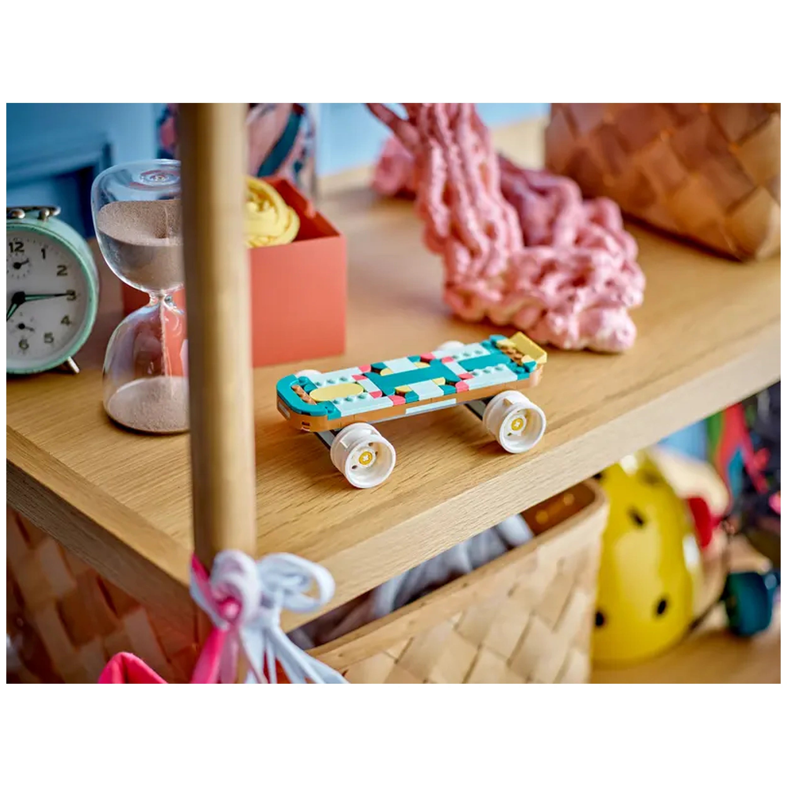 Colorful LEGO Creator Retro Roller Skate on a wooden table, surrounded by an hourglass, a pink box, and crafting materials.