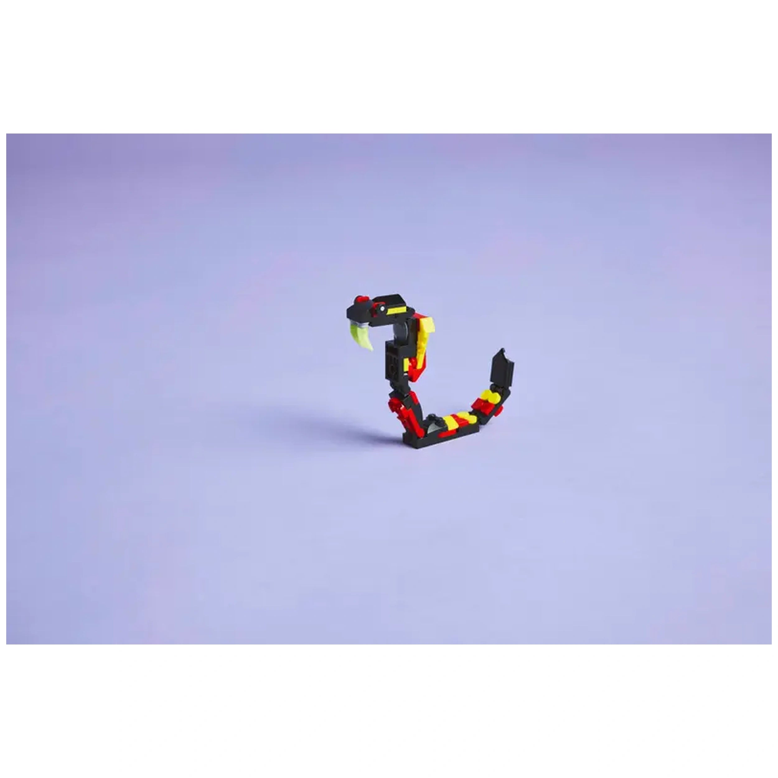 Colorful LEGO Creator Surprising Spider construction toy, featuring articulated legs and large teeth, set against a light purple background.