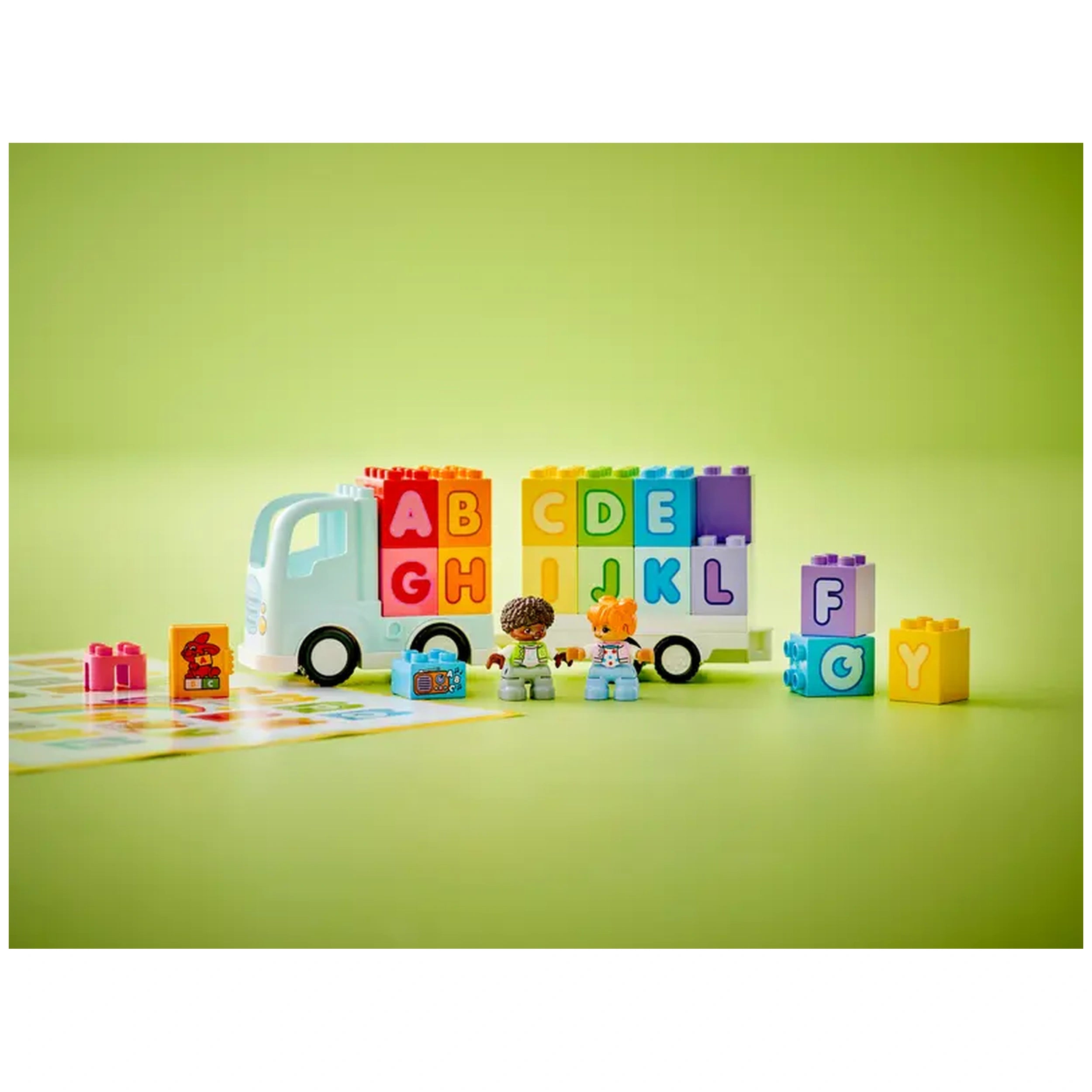Colorful LEGO® DUPLO® Alphabet Truck with detachable trailer, displaying large ABC bricks. Two toddler figures play nearby.