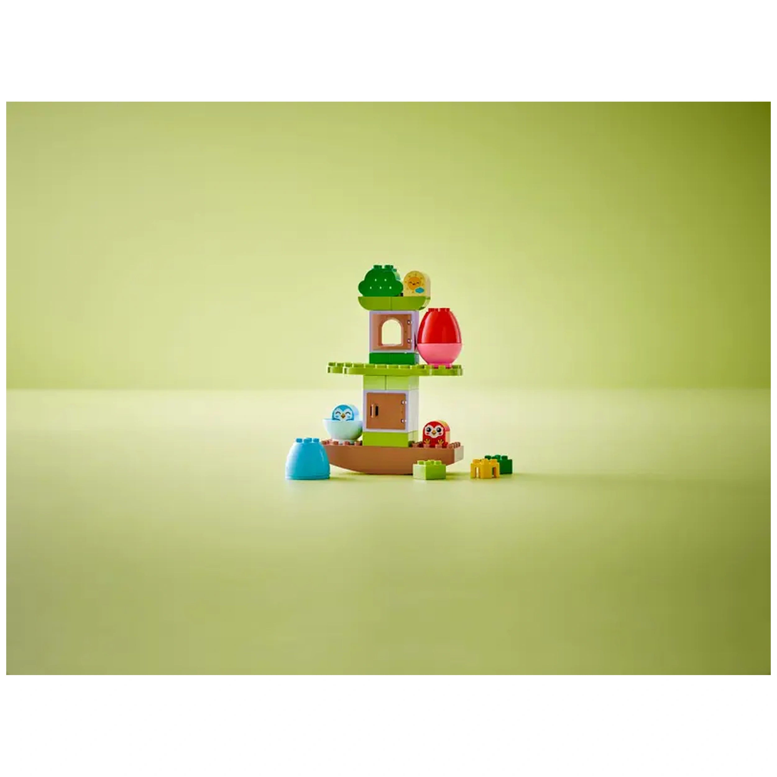 Colorful LEGO® DUPLO® Balancing & Stacking Tree set, featuring a treehouse, adorable owl figures, and playful stacking elements on a light green background.