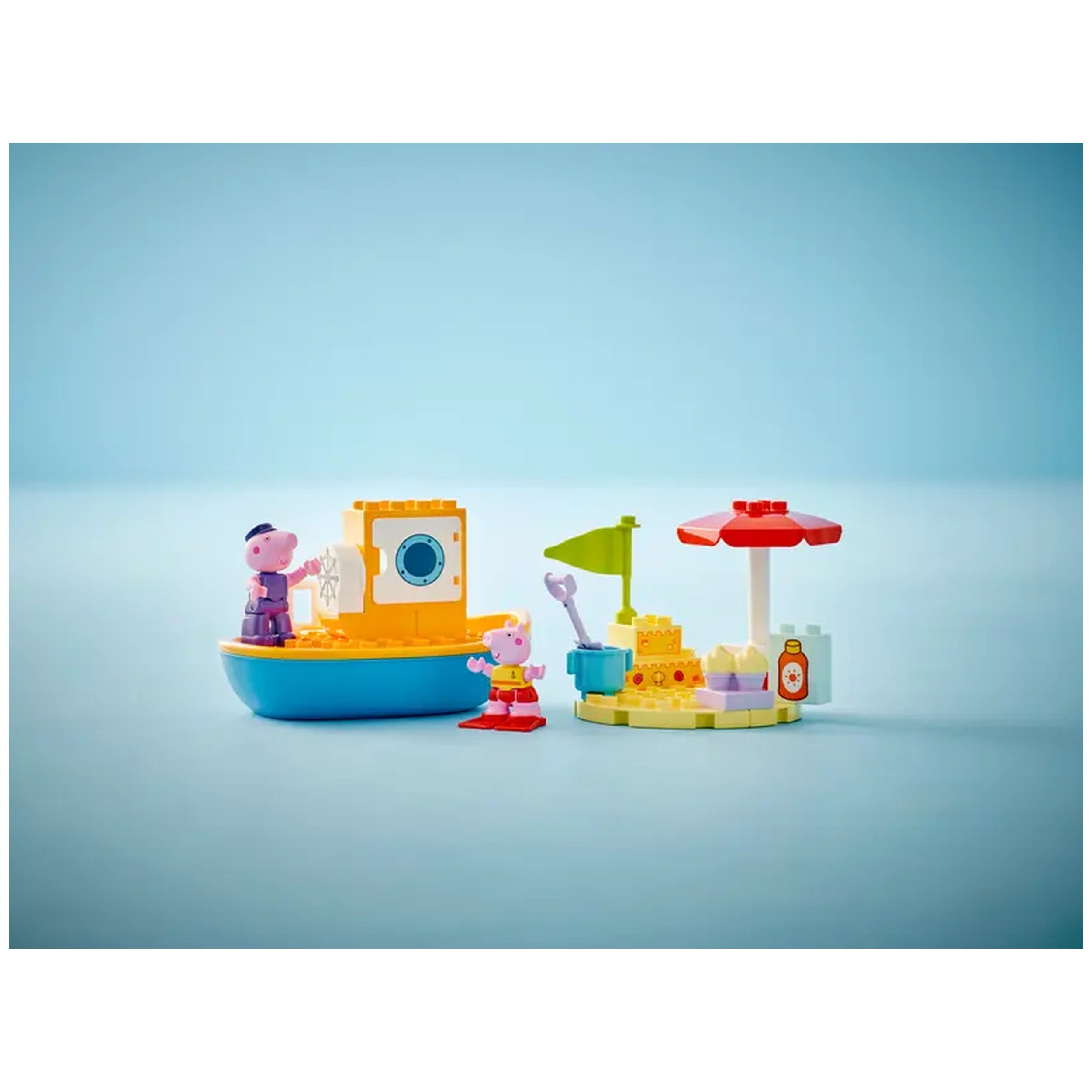 Colorful LEGO® DUPLO® Peppa Pig Boat Trip set featuring Peppa Pig and Grandpa Pig on a blue boat, with a beach scene including a sandcastle, umbrella, and tools.