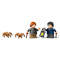 Harry Potter and Ron Weasley LEGO minifigures stand together, holding wands and a lantern, with three brown spider figures nearby.