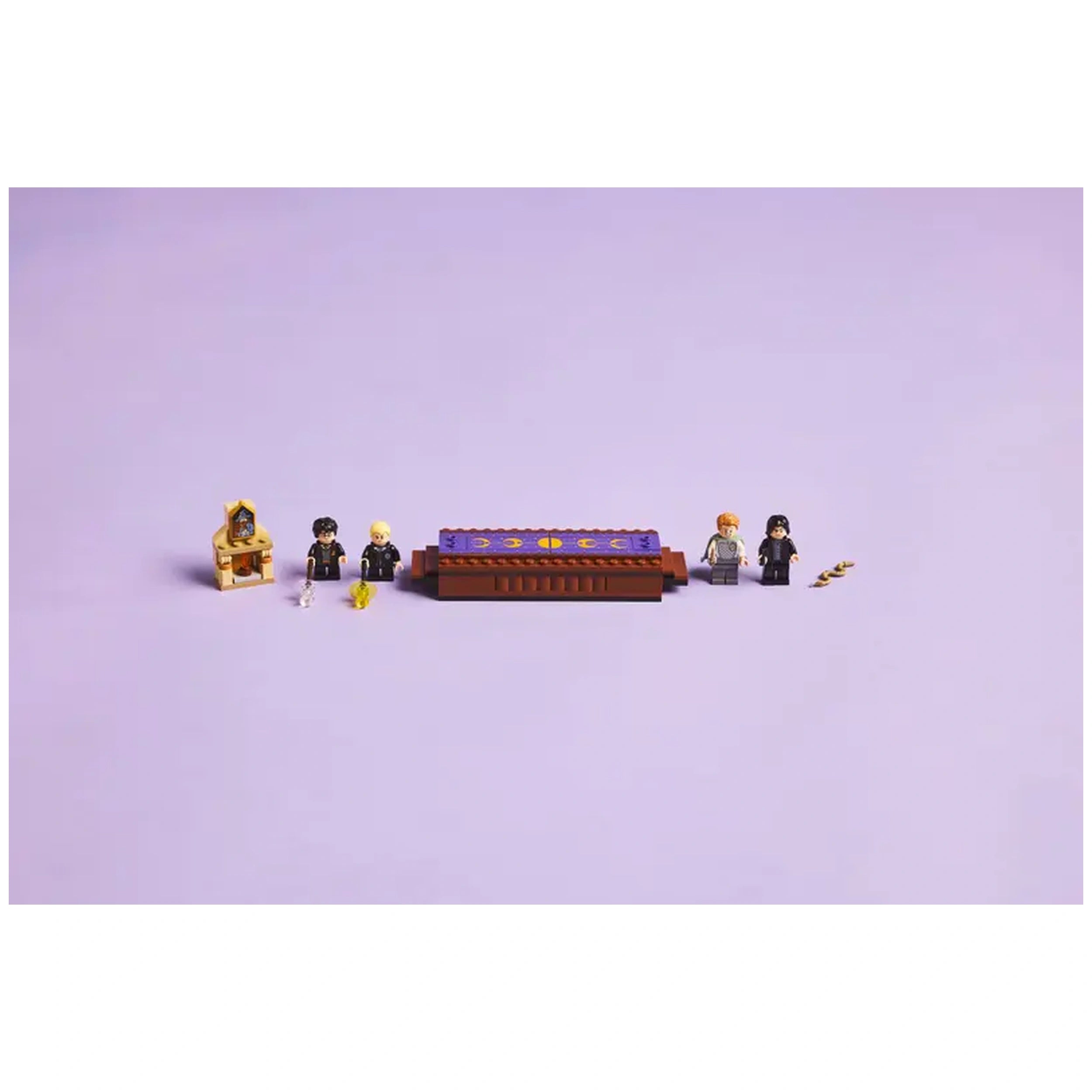 LEGO Harry Potter set featuring colorful duel platform and four minifigures: Harry, Draco, Ron, and Snape, on a light purple background.