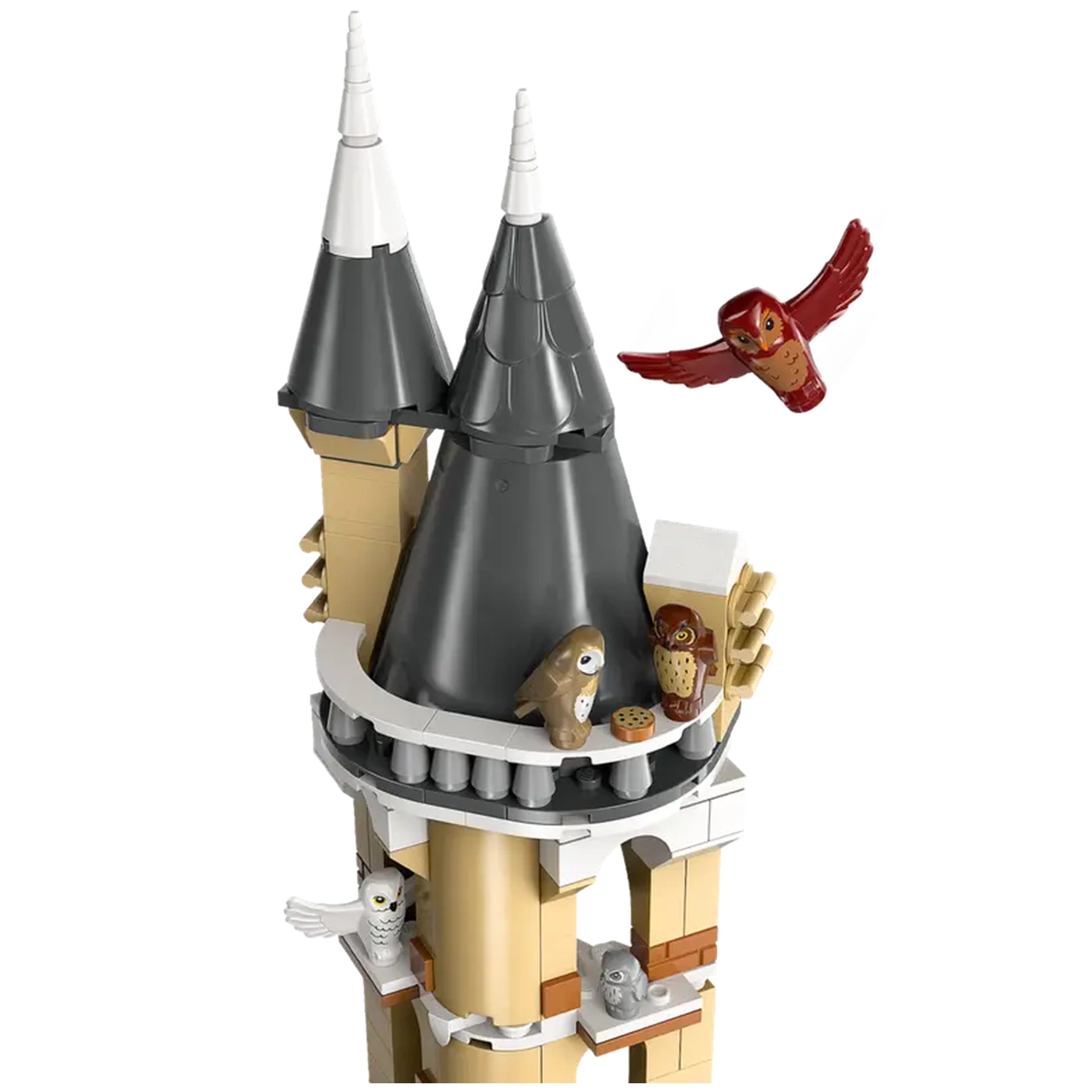 Brown and gray LEGO owl figurines perched on a stone balcony of a tower with pointed roofs. A red owl flies nearby, showcasing a magical Hogwarts environment.