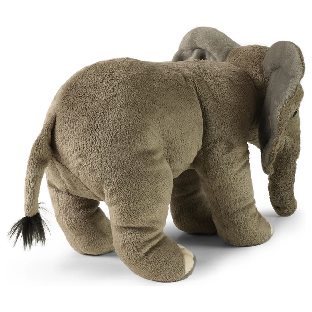 Eco-friendly plush elephant toy in gray and brown, featuring large floppy ears and a tufted tail, standing upright.