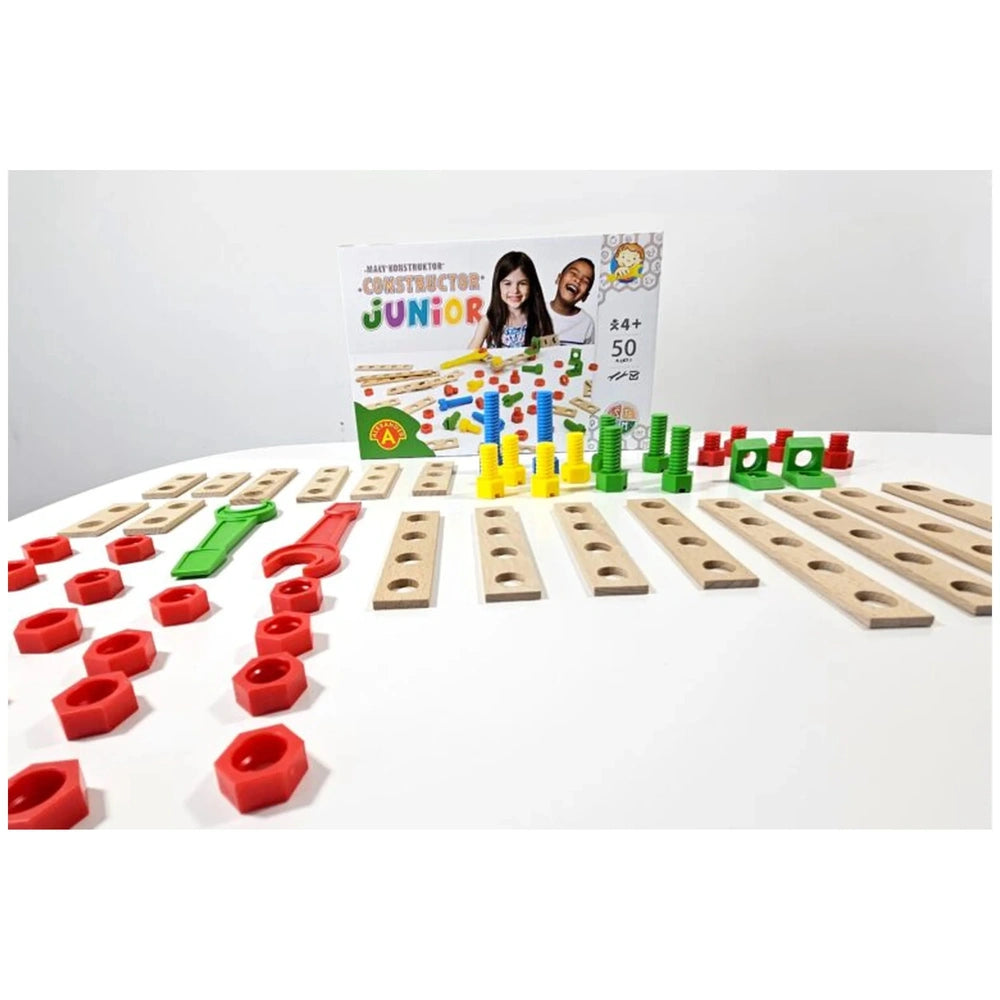 Construction set with wooden boards, red nuts, green and red wrenches, yellow and green connectors, box in background.