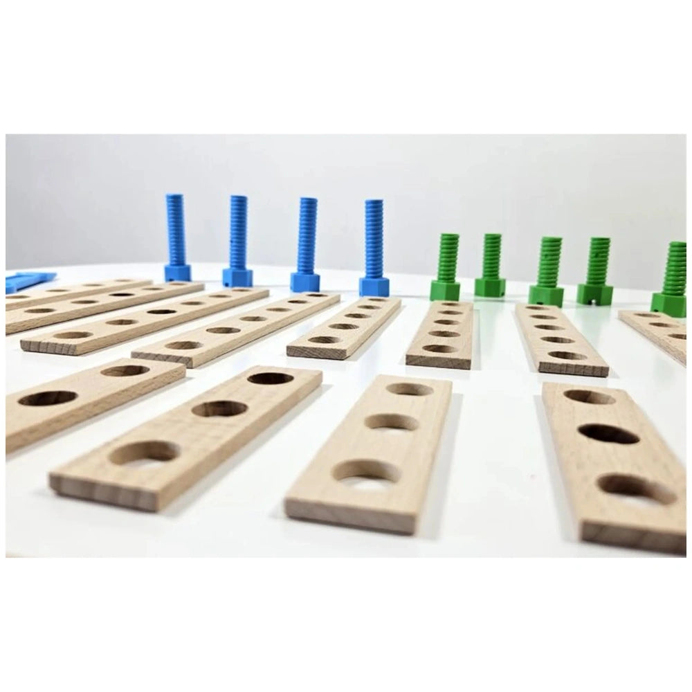 Wooden boards with holes aligned on a surface, surrounded by colorful blue and green screws from a construction set.
