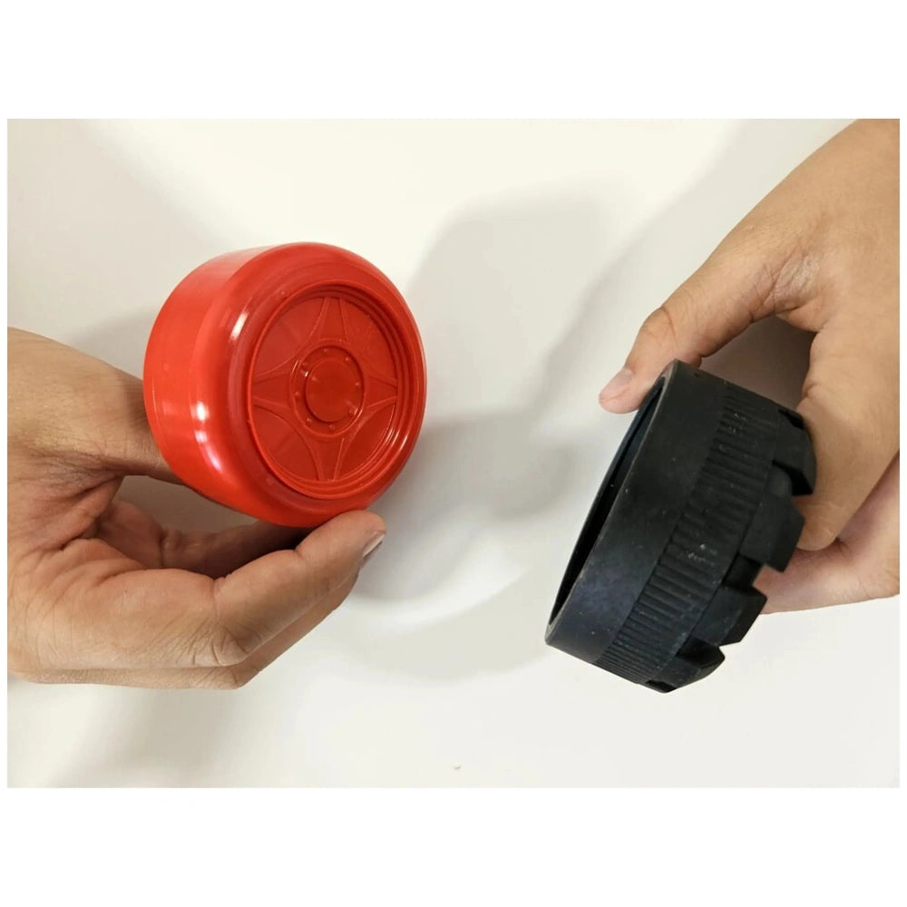 Hands holding red and black wheels from the Alexander - Maly Constructor Junior Race Car set.