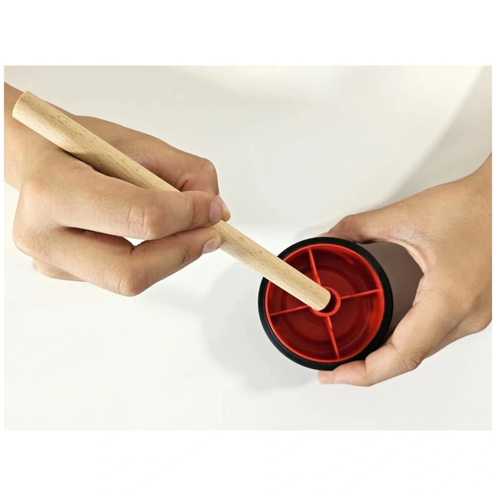 Hand assembling a red and black race car wheel with a wooden axle from the Alexander Maly Constructor Junior set.