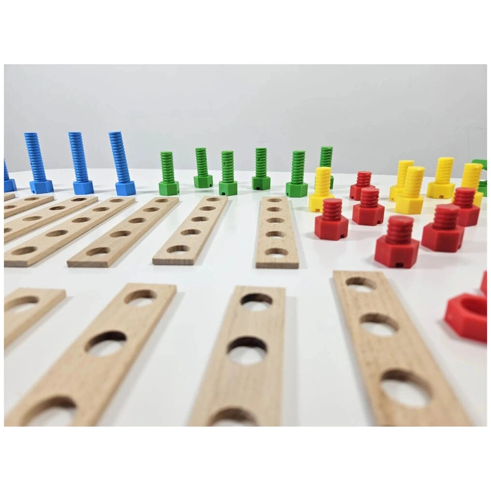 Colorful screws and nuts with wooden boards from the Alexander Maly Constructor Junior Race Car set arranged on a white surface.