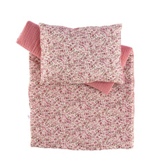Floral pink and white comforter and pillow set for dolls, showcasing cozy quilted design and pattern.