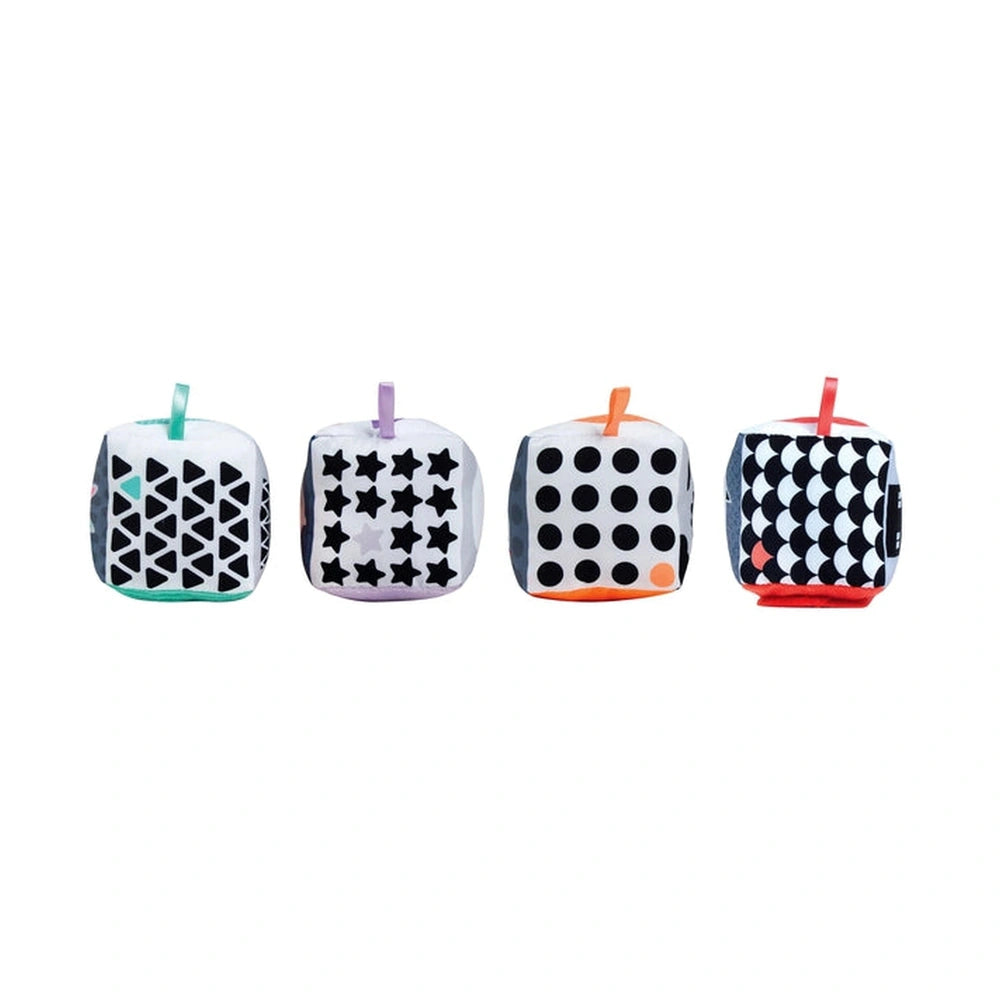Baby Clementoni soft activity blocks in black and white with stars and polka dots, featuring vibrant orange accents.