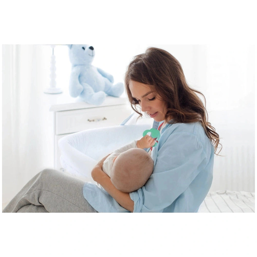 Baby Clementoni Doudou Sweet Bunny Comforter held by a woman in a blue shirt, with a teddy bear on a white dresser.