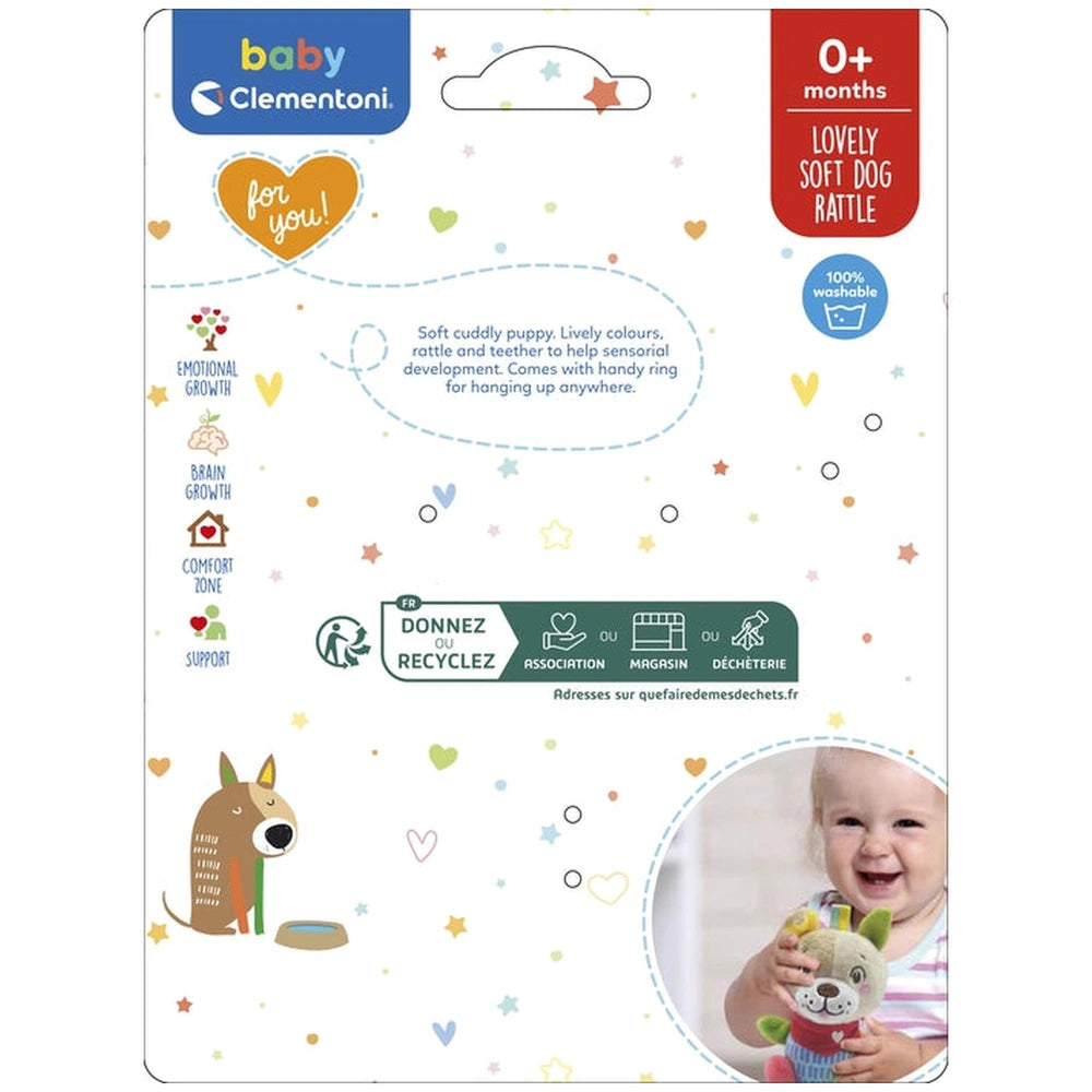 Baby Clementoni Lovely Soft Dog Rattle packaging features a transparent window, colorful star and heart pattern, and product 