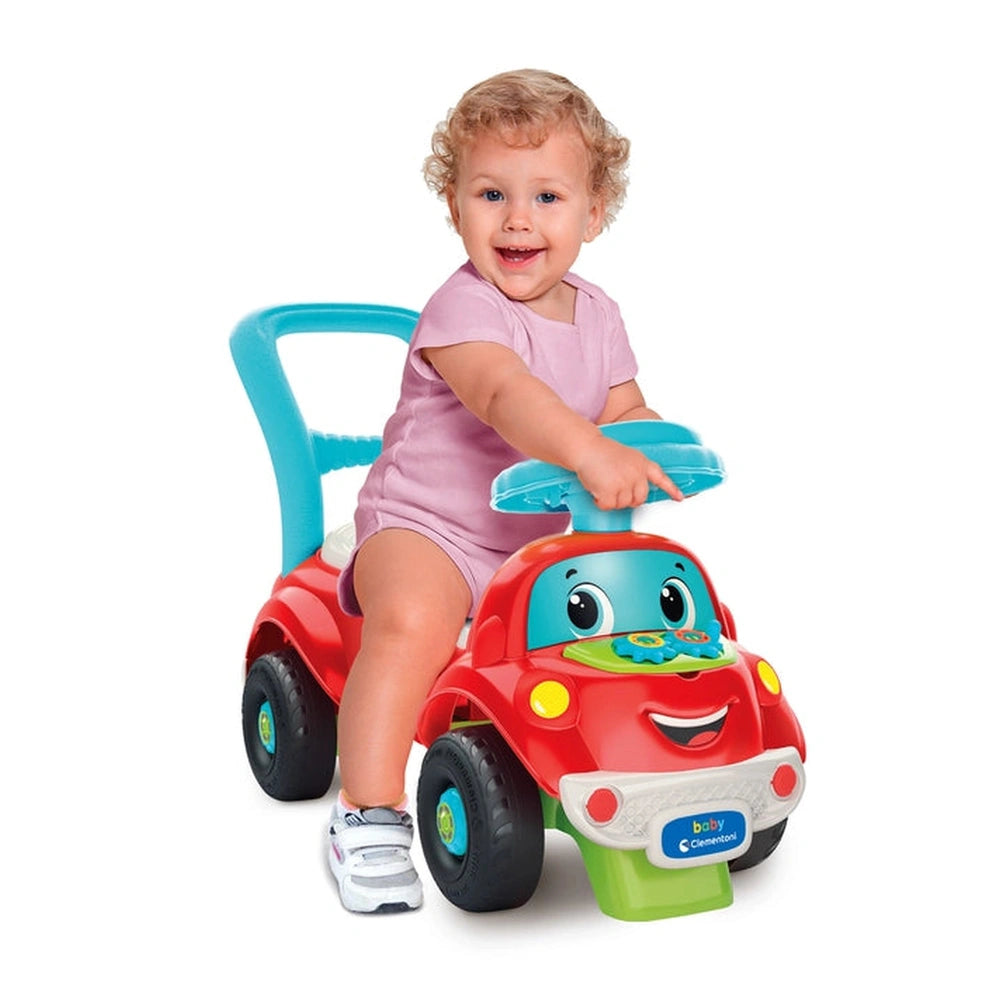 Baby Clementoni Nicolo Go Go 3 In 1 Riding Toy features a child in a pink shirt sitting on a colorful toy car with a blue ste