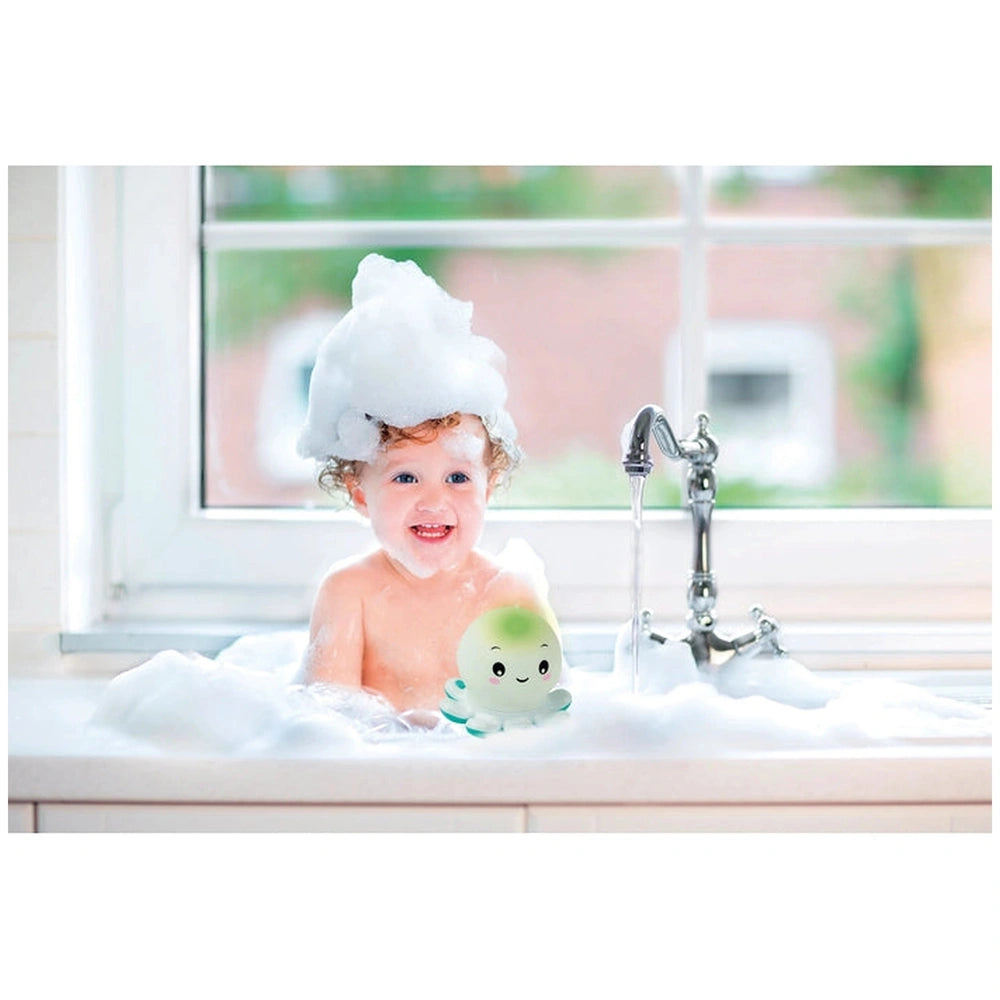 Baby Clementoni Octo Baby Bath Toys in a bubbly bathtub, held by a child wearing a white towel on their head.